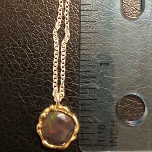 Sterling silver with genuine Ethiopian black opal on chain. Adjustable to 20”